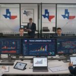 Six people in business attire work in a modern office with multiple monitors displaying graphs, analytics dashboards, and SEO techniques. Texas state maps and flags are visible on the walls, highlighting the focus on Texas payday lenders.